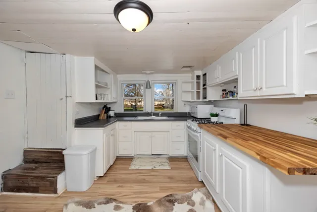 a kitchen with stainless steel appliances granite countertop a sink and cabinets