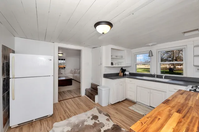 a kitchen with white cabinets and white appliances