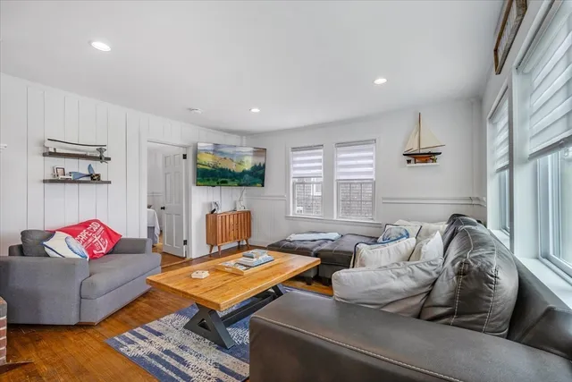 a living room with furniture rug and window