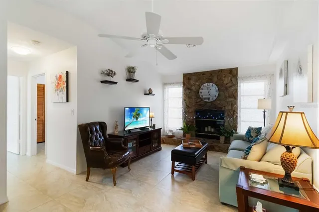 a living room with furniture a fireplace and a flat screen tv