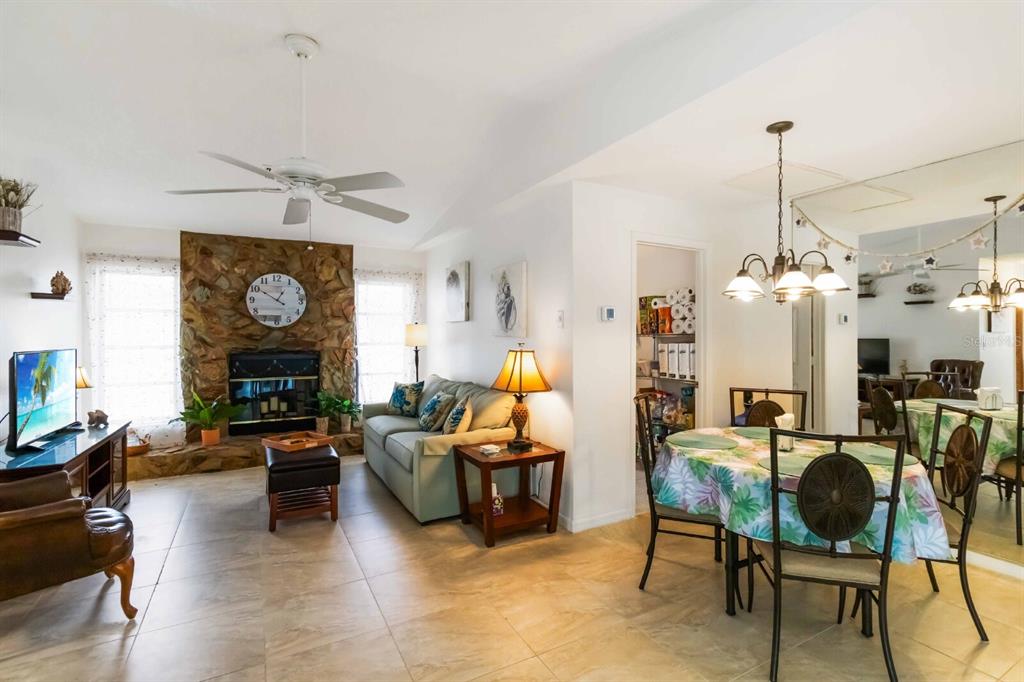18606 Briggs Circle Port Charlotte, FL 33948 - Photo 14 of 44 a living room with furniture a chandelier and a fireplace