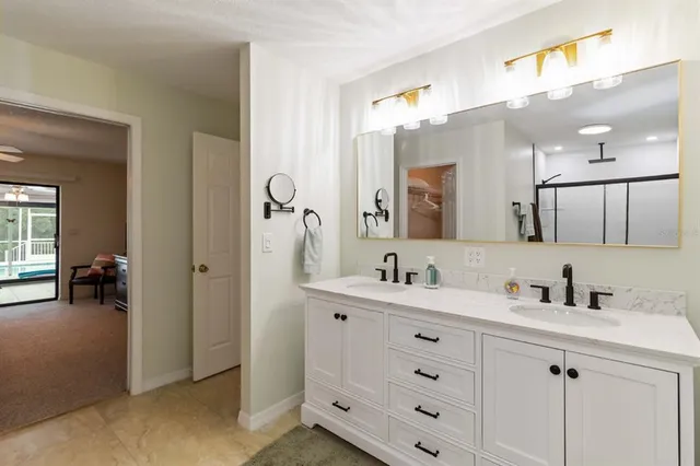 a bathroom with a double vanity sink and a mirror