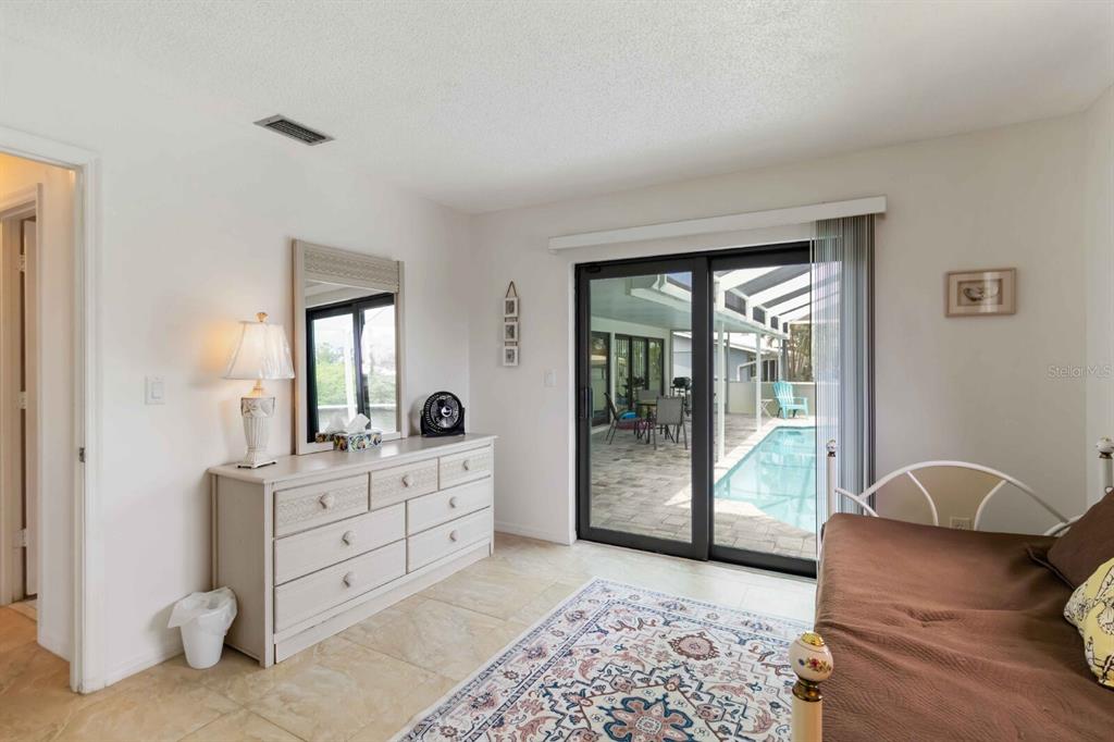 18606 Briggs Circle Port Charlotte, FL 33948 - Photo 18 of 44 a bedroom with a bed and wooden floor