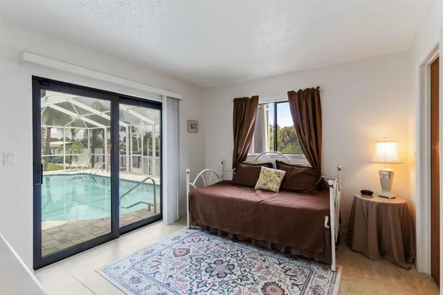 a bedroom with a bed and glass window