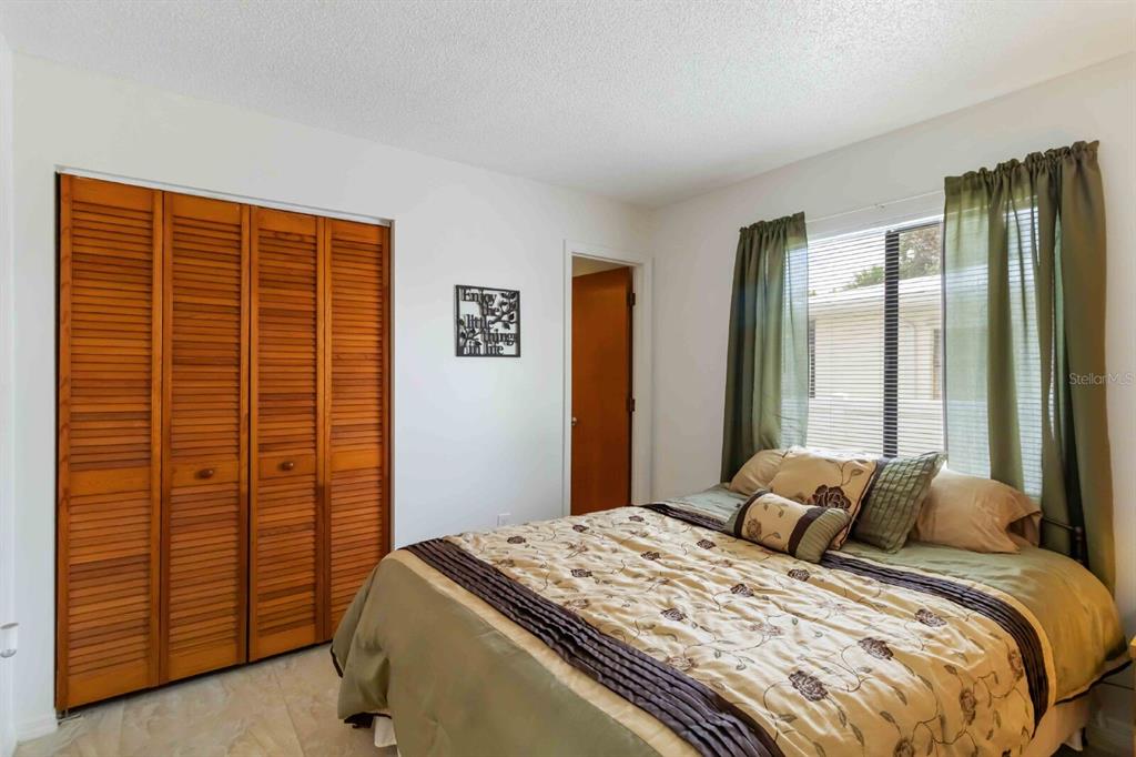 18606 Briggs Circle Port Charlotte, FL 33948 - Photo 21 of 44 a bedroom with a bed and a cabinet