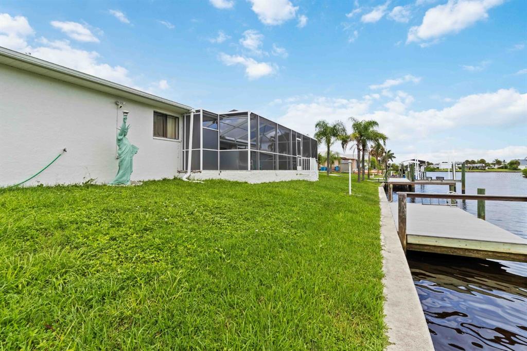 18606 Briggs Circle Port Charlotte, FL 33948 - Photo 34 of 44 a view of a backyard with plants and a patio