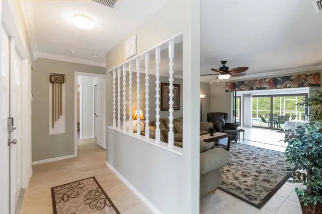 a view of a hallway with living room and dining room