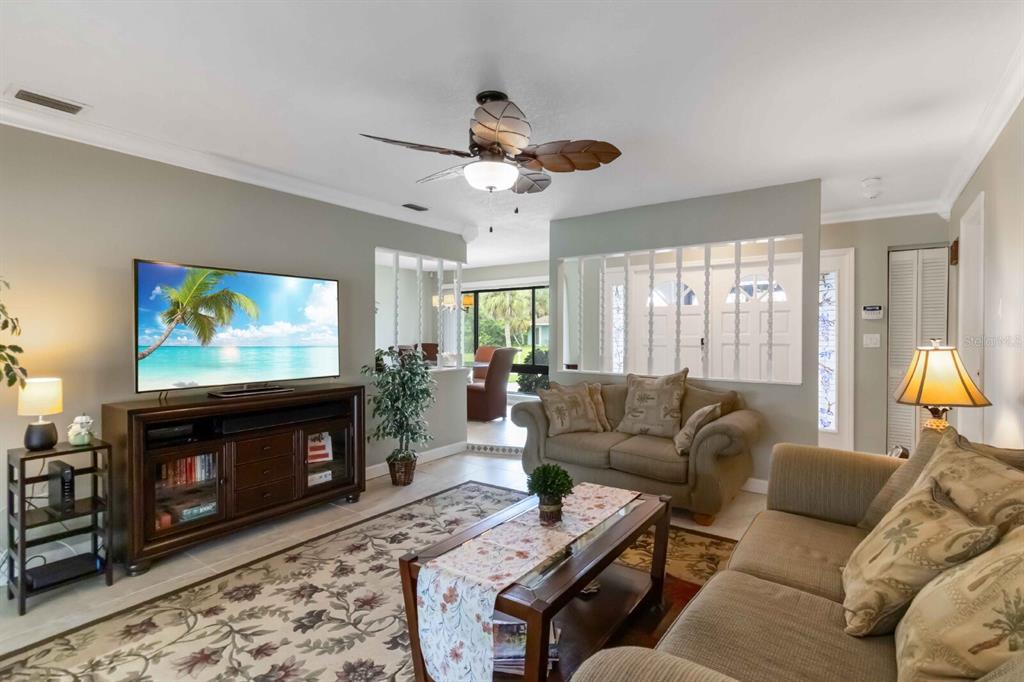 18606 Briggs Circle Port Charlotte, FL 33948 - Photo 6 of 44 a living room with furniture a flat screen tv and a fireplace