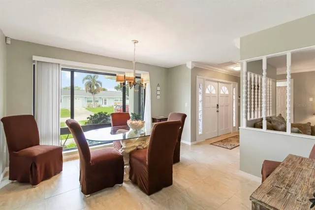 a living room with furniture and large windows