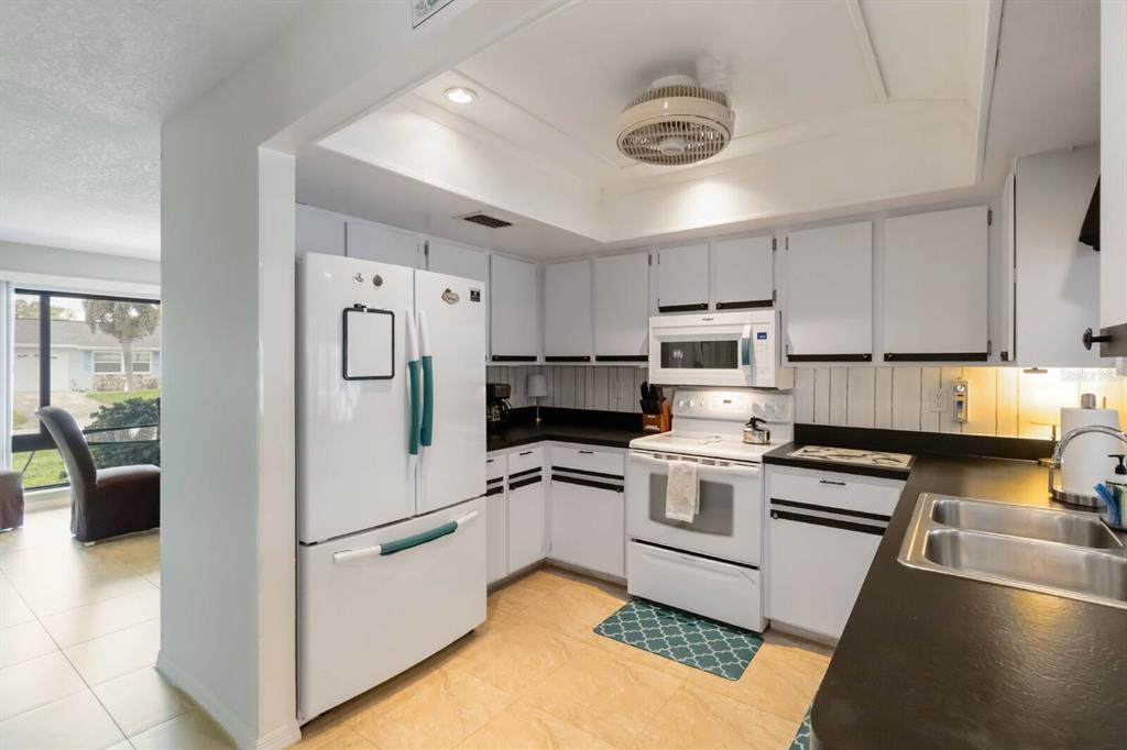 18606 Briggs Circle Port Charlotte, FL 33948 - Photo 9 of 44 a kitchen with granite countertop a refrigerator stove and sink