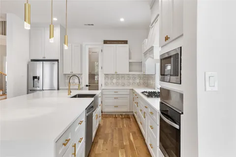 a kitchen with a sink stove and refrigerator