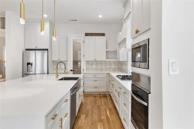 a kitchen with a sink stove and refrigerator