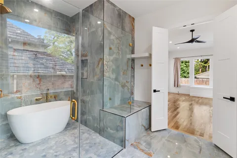 a bathroom with a bathtub and shower