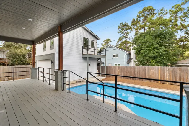 a view of a deck with chairs and wooden floor