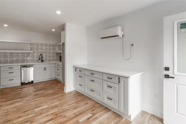 a spacious bathroom with a double vanity sink a mirror and a bathtub
