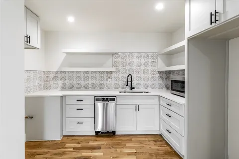 a kitchen with cabinets appliances and a counter space