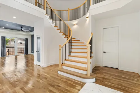 a view of entryway and hall with wooden floor
