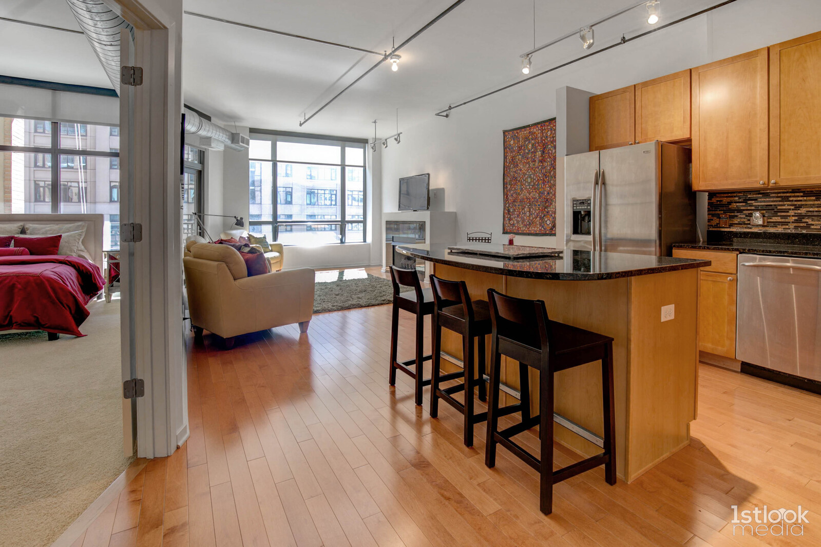 520 South State Street, Unit 1103 Chicago, IL 60605 - Photo 6 of 43 a kitchen with stainless steel appliances granite countertop a stove a refrigerator a dining table and chairs with wooden floor
