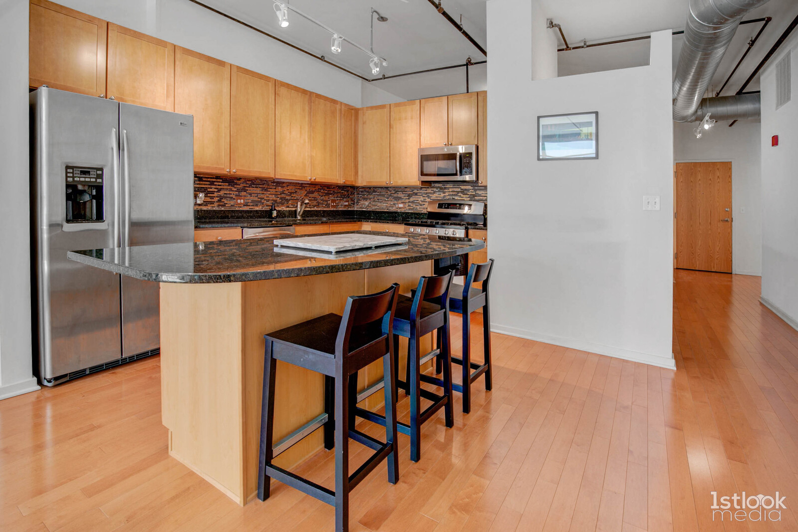 520 South State Street, Unit 1103 Chicago, IL 60605 - Photo 7 of 43 a kitchen with stainless steel appliances granite countertop a stove a refrigerator and a dining table