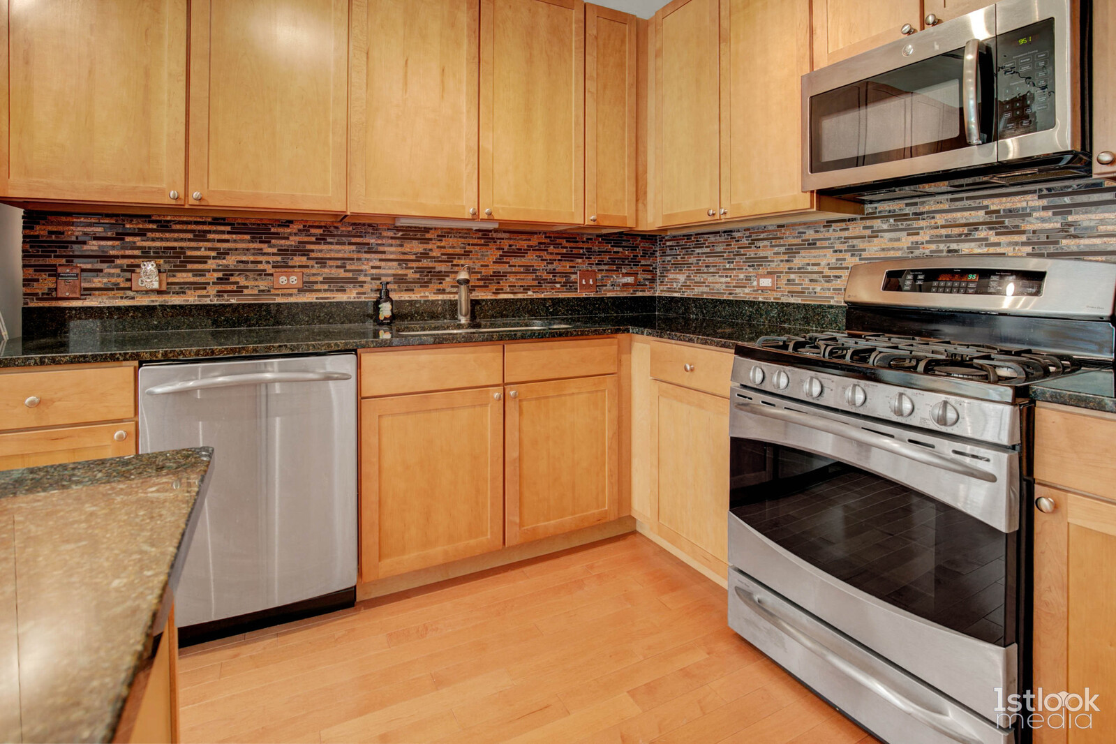 520 South State Street, Unit 1103 Chicago, IL 60605 - Photo 8 of 43 a kitchen with stainless steel appliances granite countertop a stove and a microwave