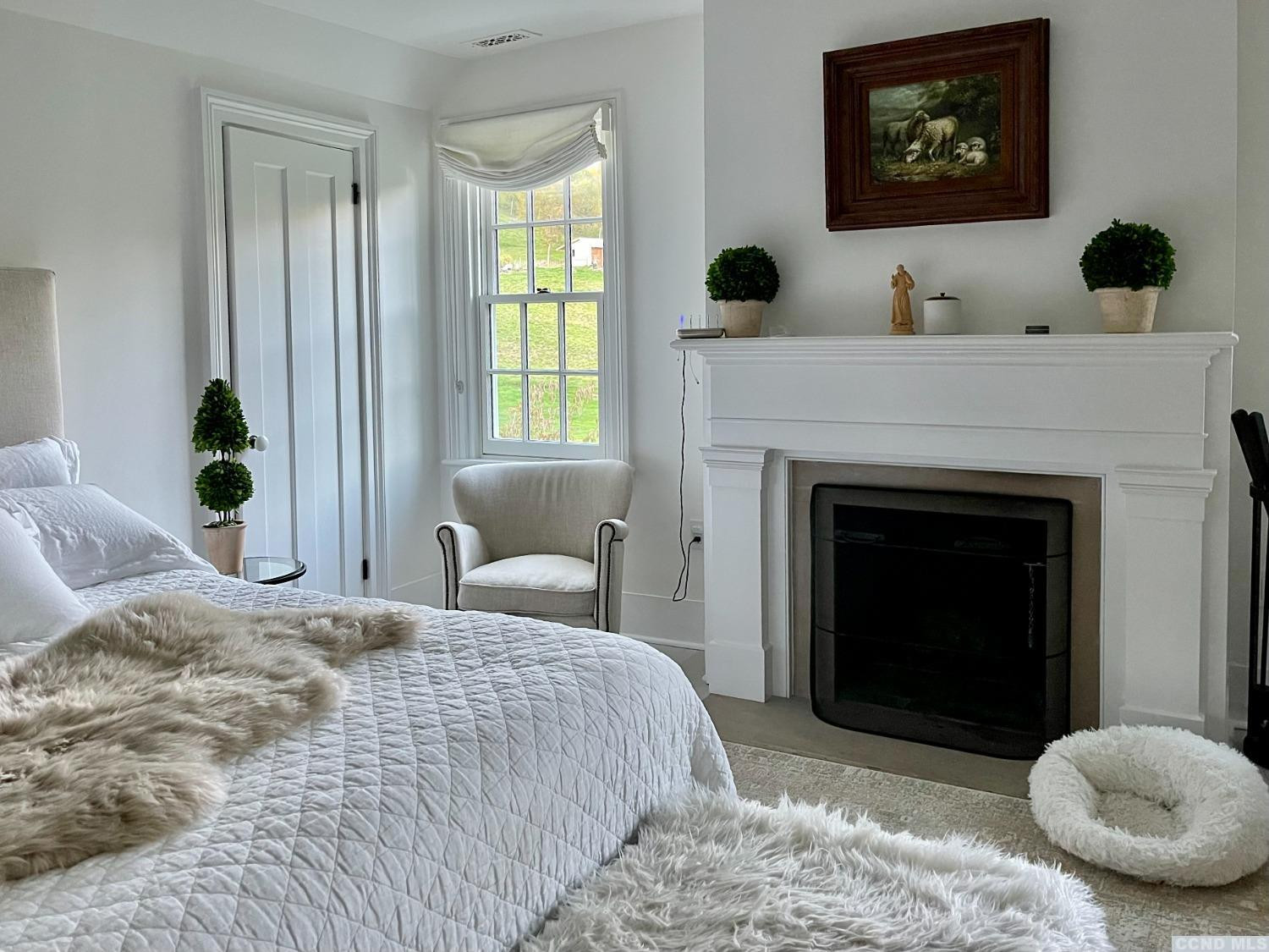 739 Center Hill Road Copake, NY 12516 - Photo 16 of 28 a bedroom with a bed and a fireplace