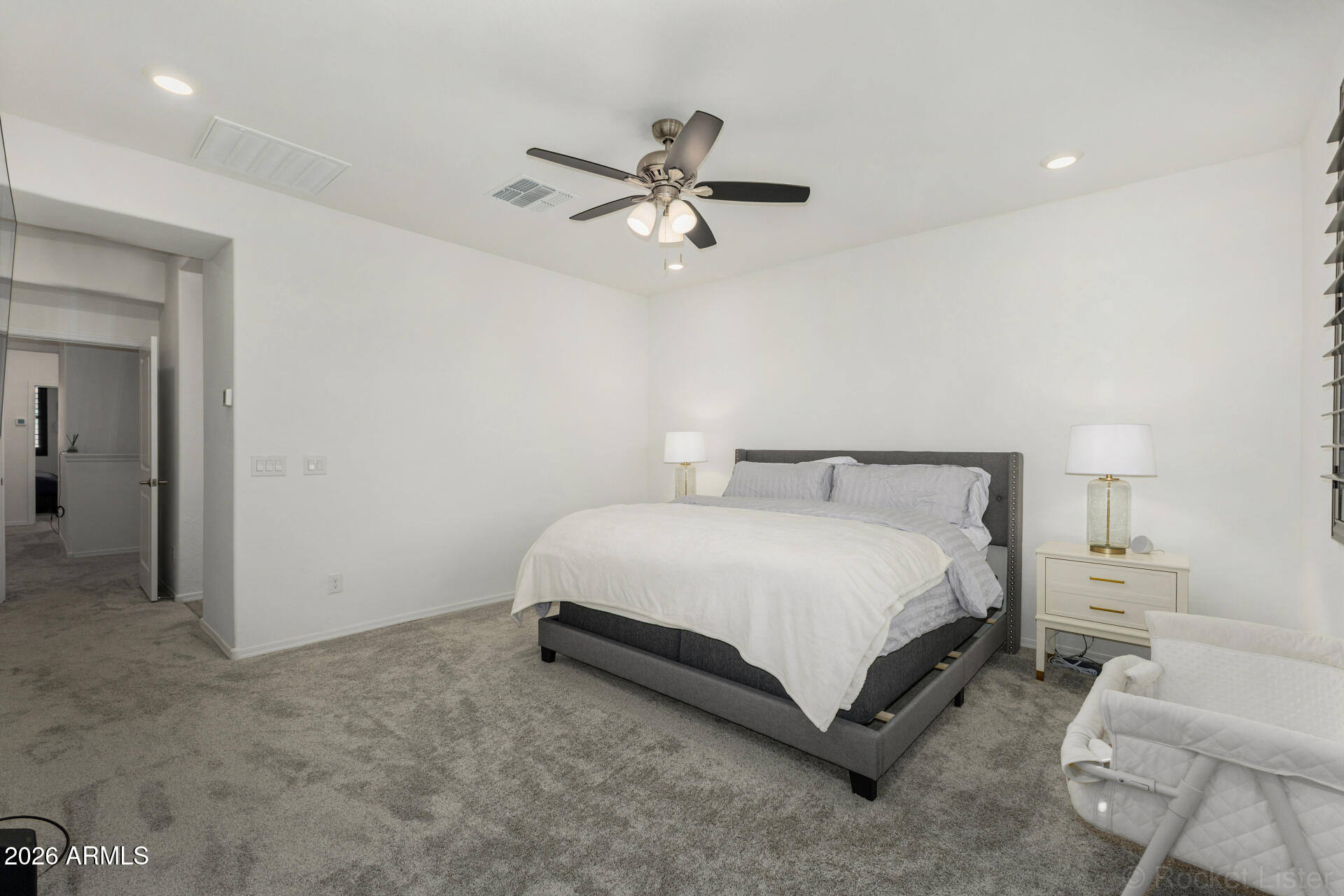 1917 East Hampton Lane, Unit 104 Gilbert, AZ 85295 - Photo 12 of 39 a bedroom with a bed rug and ceiling fan