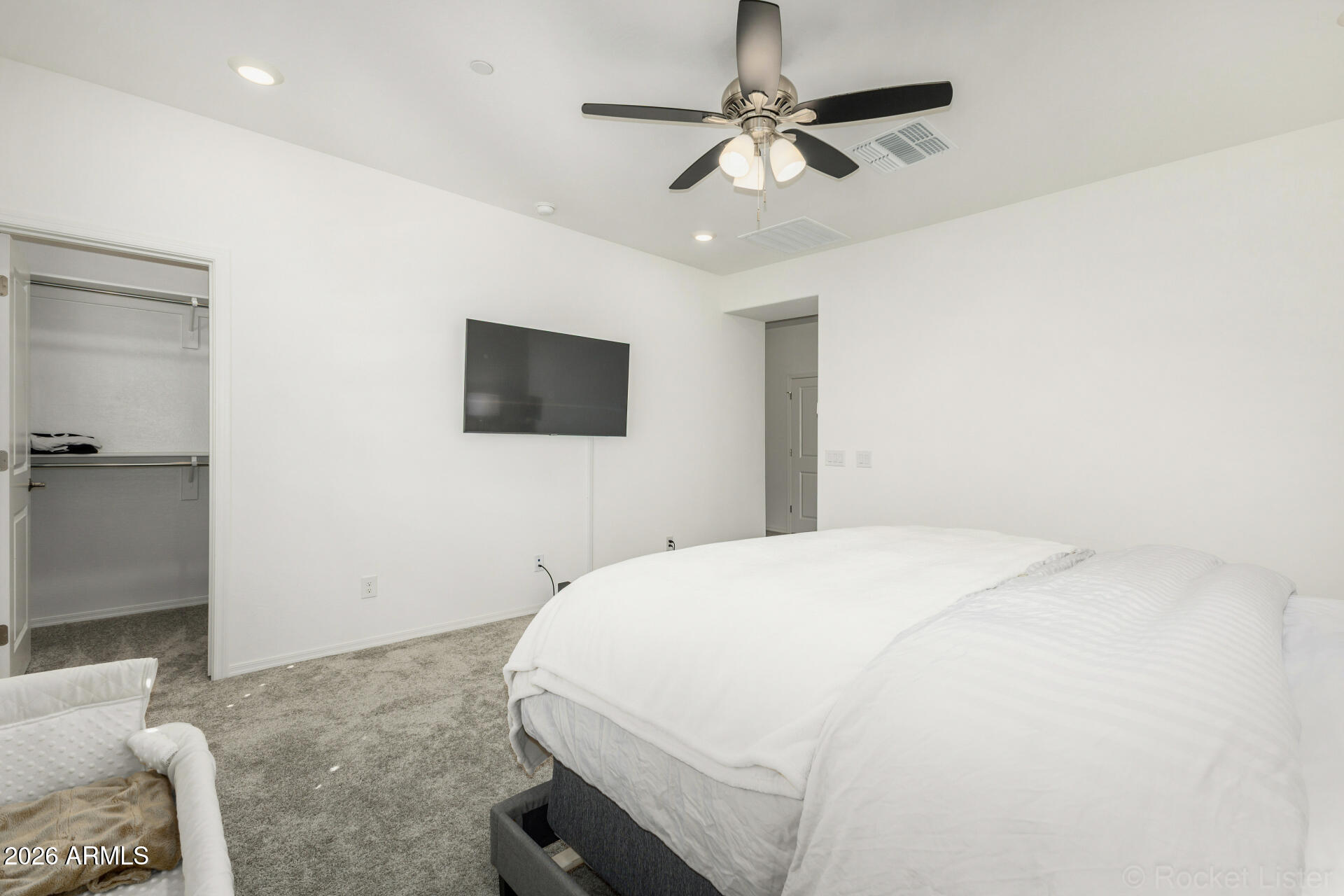 1917 East Hampton Lane, Unit 104 Gilbert, AZ 85295 - Photo 13 of 39 a bedroom with a bed and a flat screen tv