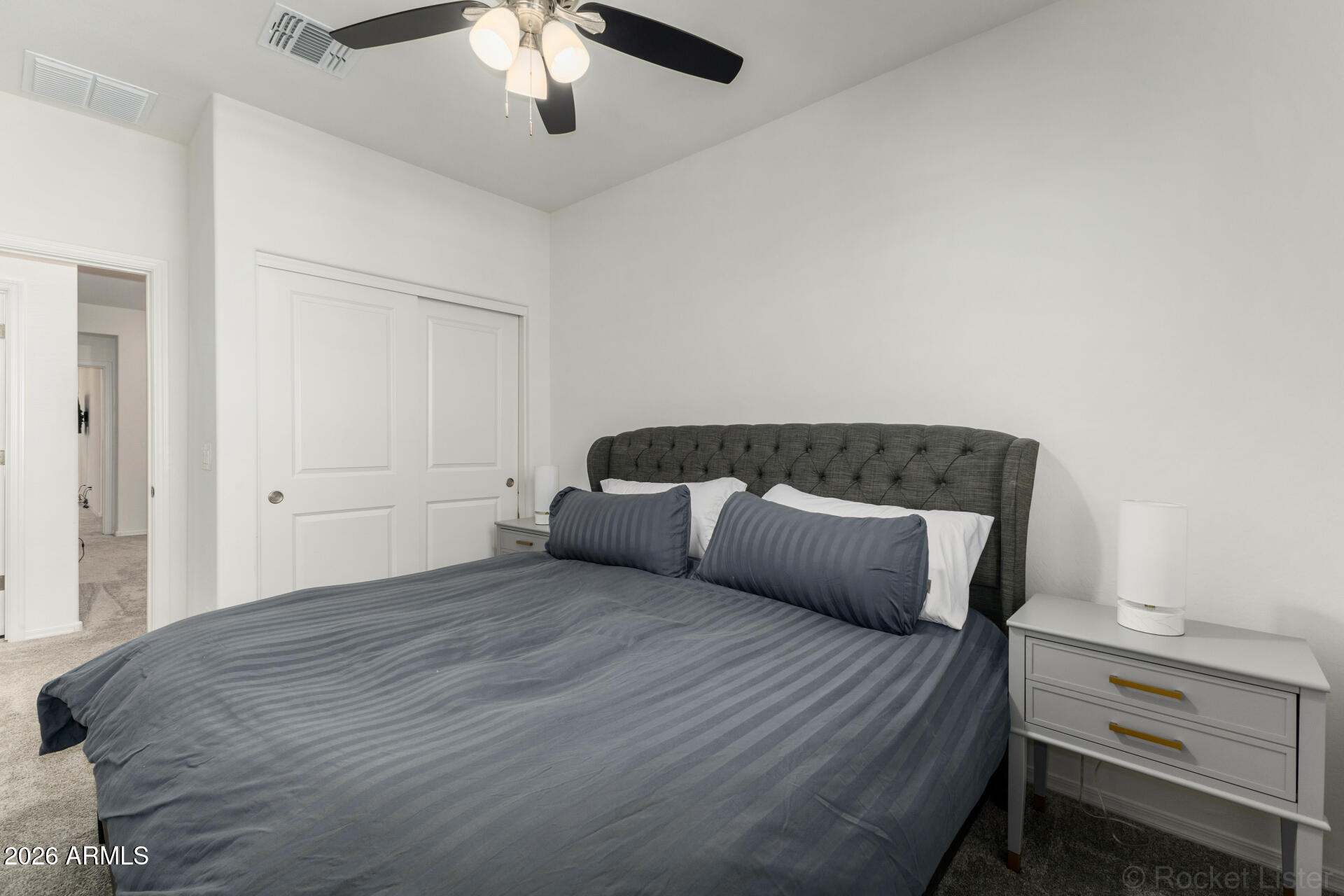 1917 East Hampton Lane, Unit 104 Gilbert, AZ 85295 - Photo 18 of 39 a bedroom with a bed and a chandelier