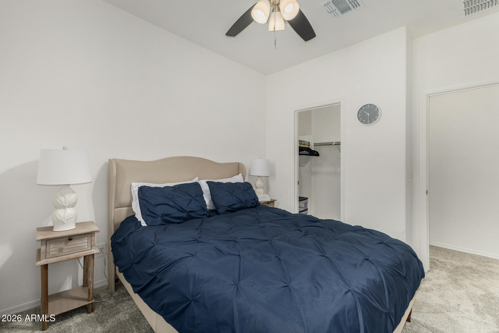 1917 East Hampton Lane, Unit 104 Gilbert, AZ 85295 - Photo 20 of 39 a bedroom with a bed and a chandelier