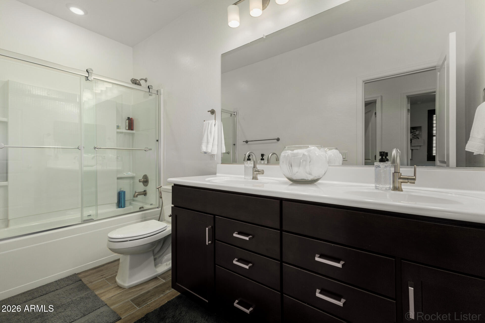 1917 East Hampton Lane, Unit 104 Gilbert, AZ 85295 - Photo 21 of 39 a bathroom with a double vanity sink toilet and shower