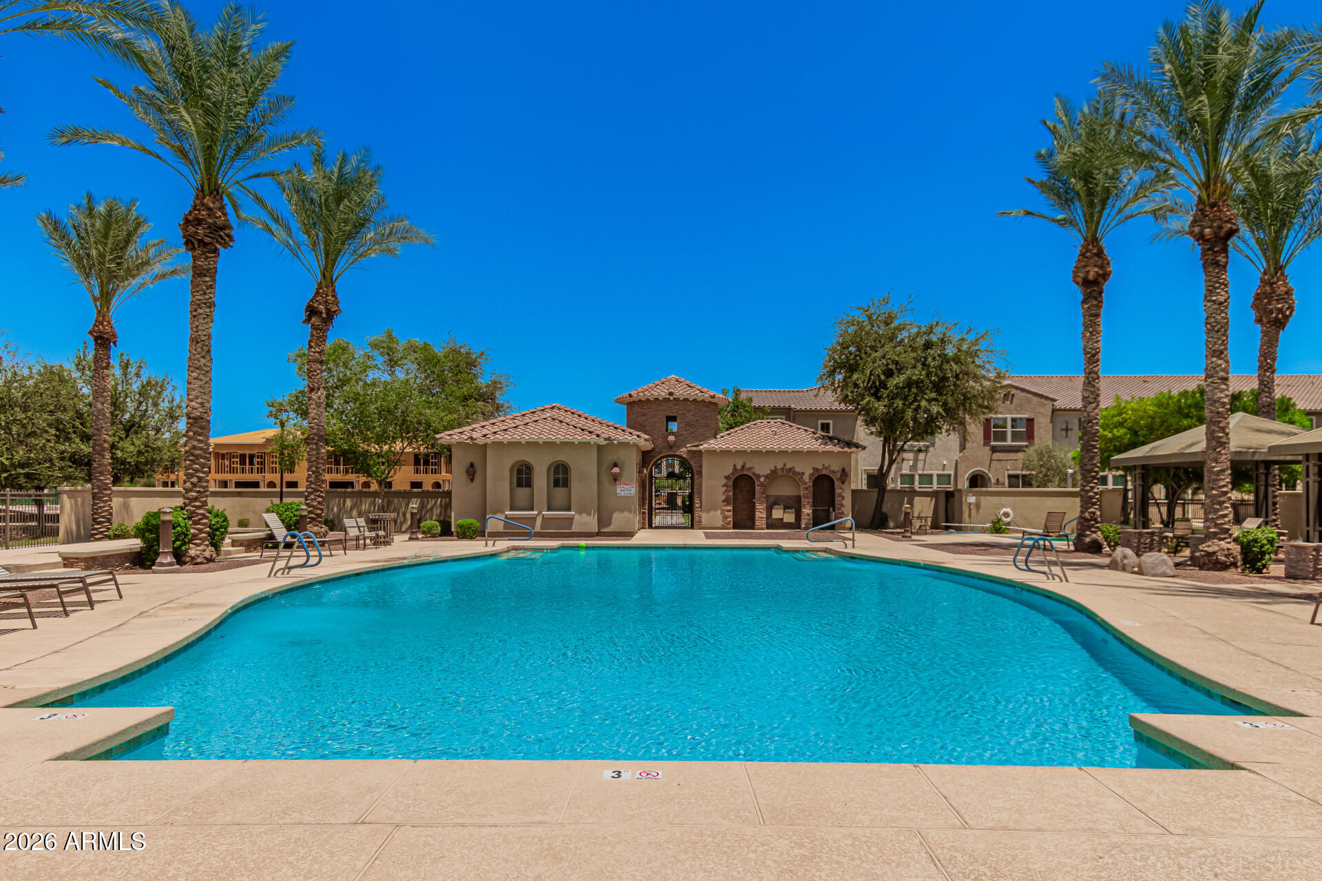 1917 East Hampton Lane, Unit 104 Gilbert, AZ 85295 - Photo 30 of 39 a view of swimming pool with outdoor seating and house in the background