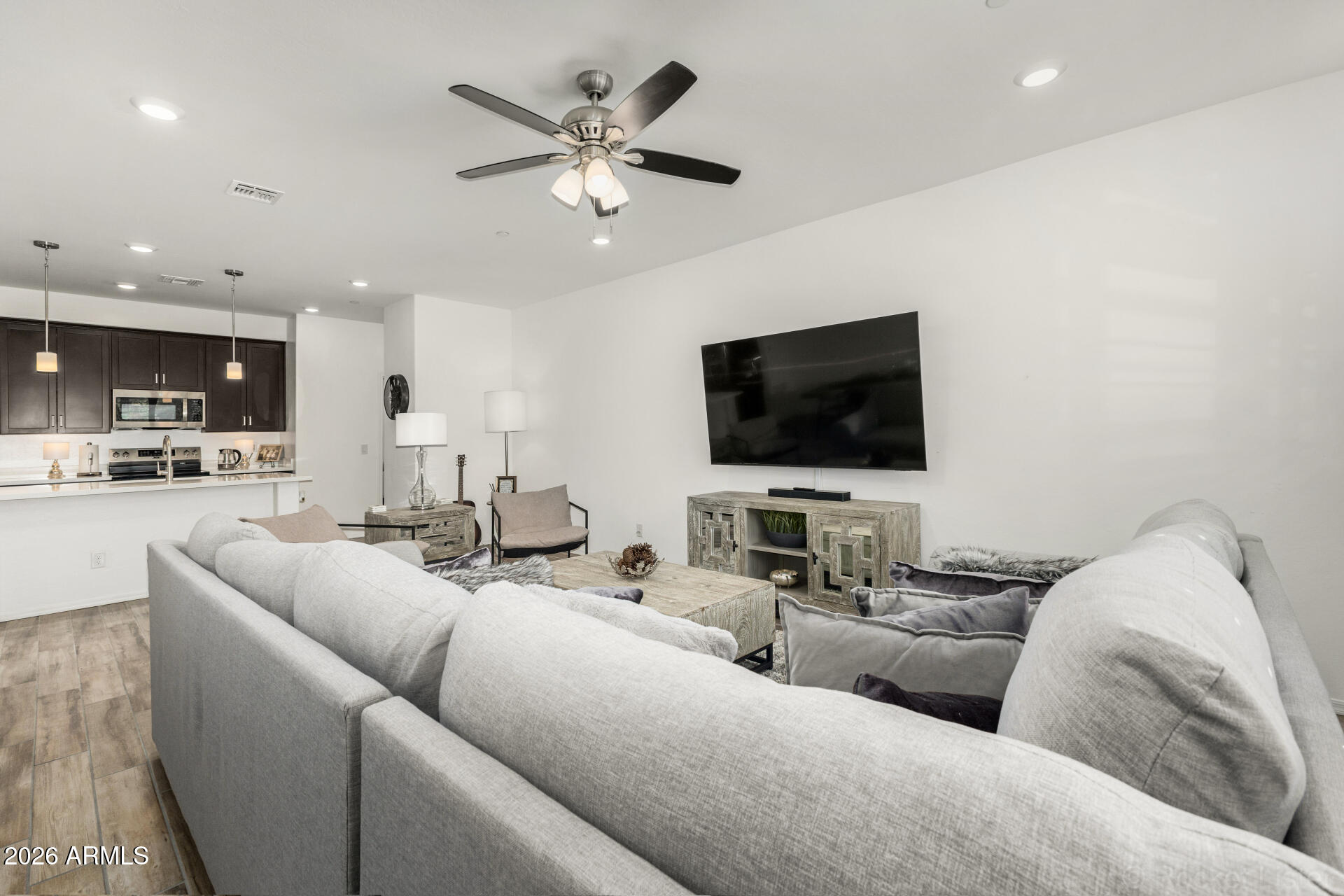 1917 East Hampton Lane, Unit 104 Gilbert, AZ 85295 - Photo 6 of 39 a living room with furniture and a flat screen tv