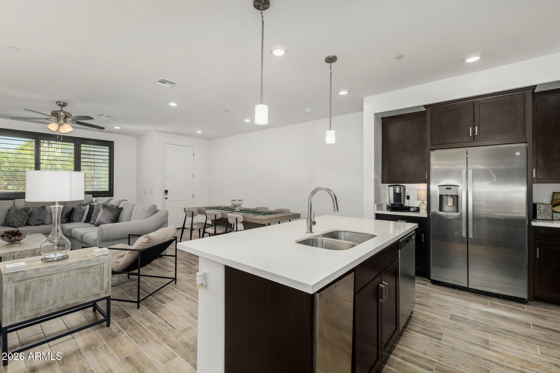1917 East Hampton Lane, Unit 104 Gilbert, AZ 85295 - Photo 8 of 39 a kitchen with a sink a counter space and stainless steel appliances