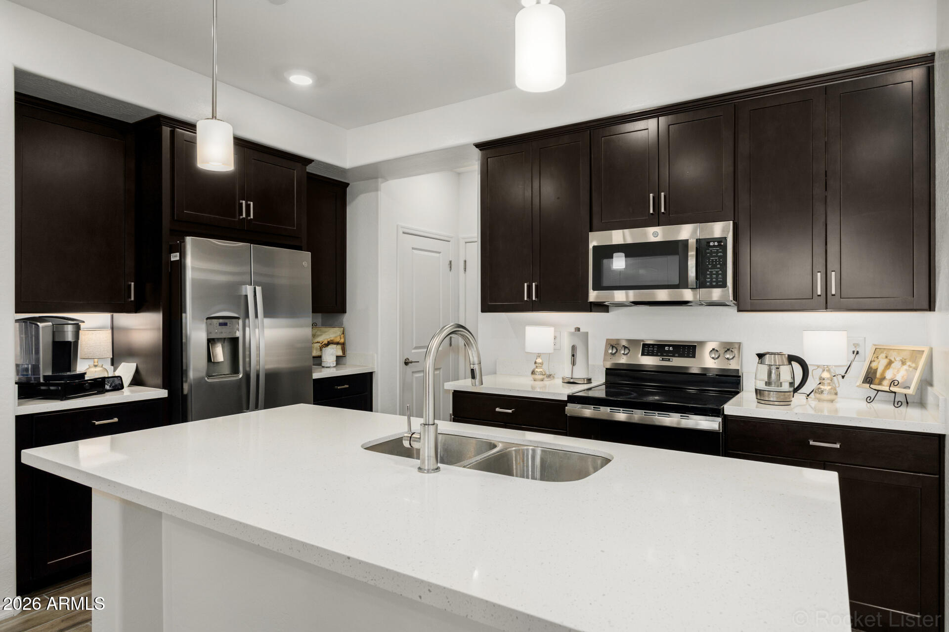 1917 East Hampton Lane, Unit 104 Gilbert, AZ 85295 - Photo 9 of 39 a kitchen with stainless steel appliances a sink stove refrigerator and cabinets