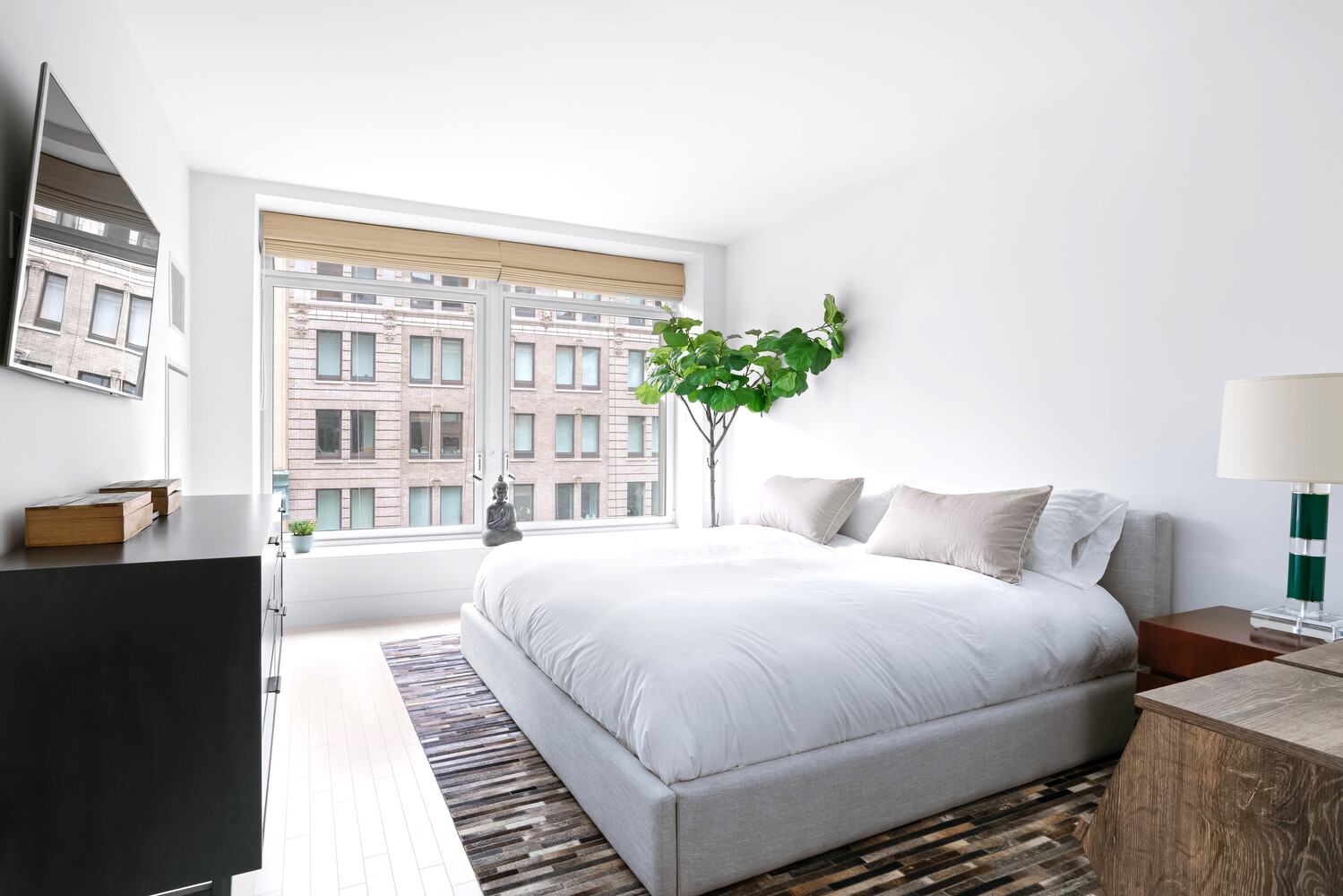 91 Leonard Street, Unit 8B Manhattan, NY 10013 - Photo 6 of 16 a bedroom with a bed painting on wall and a large window