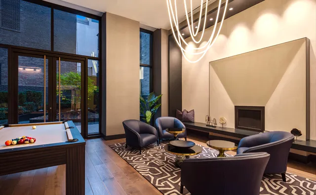 a living room with furniture and a floor to ceiling window