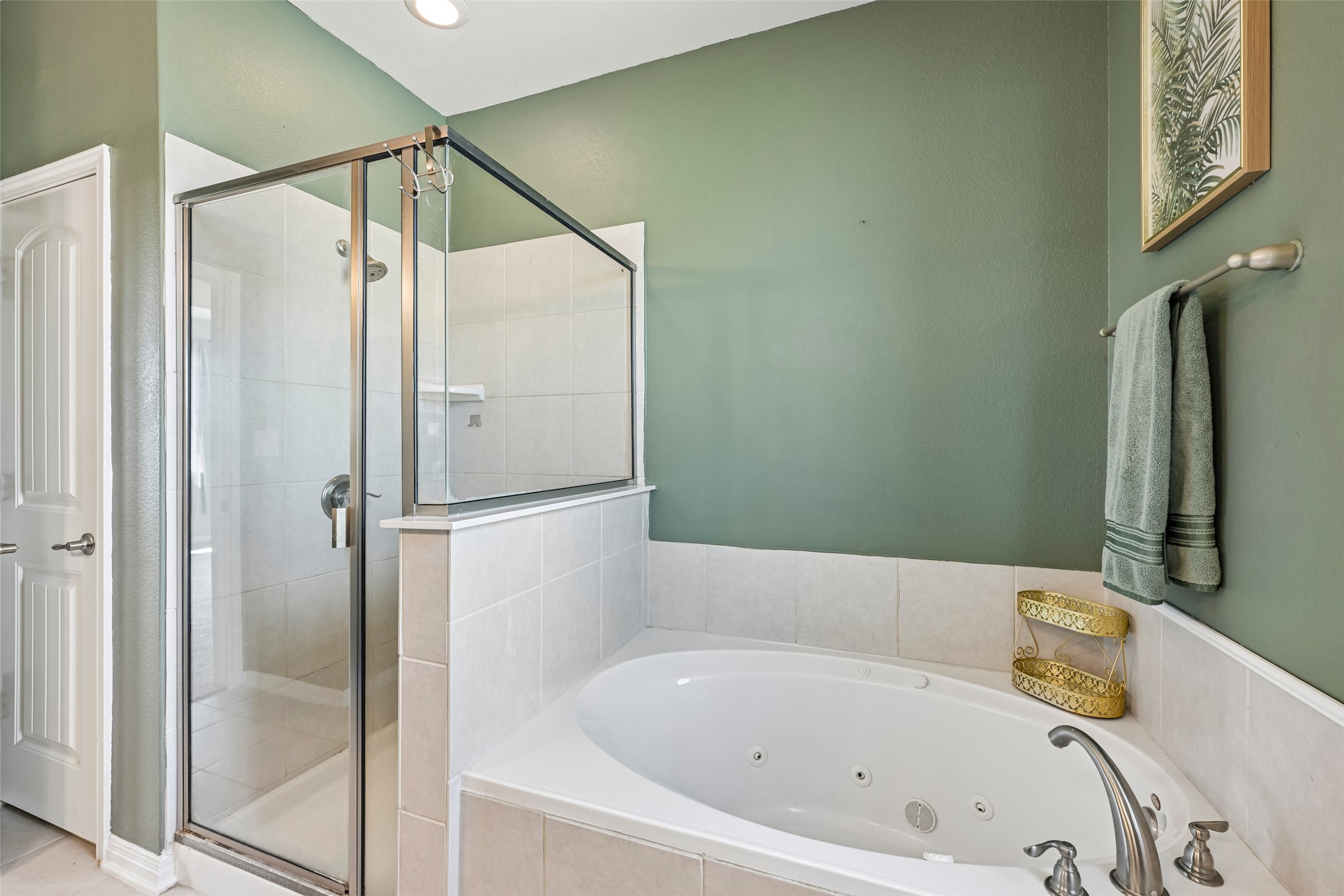 1297 Harwell Loop Kyle, TX 78640 - Photo 22 of 39 Indulge in a tranquil retreat with this bathroom's corner soaking tub and glass-enclosed shower.