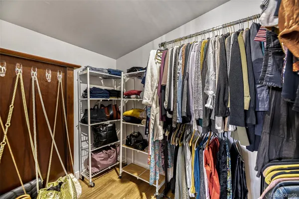 a view of walk in closet with clothes