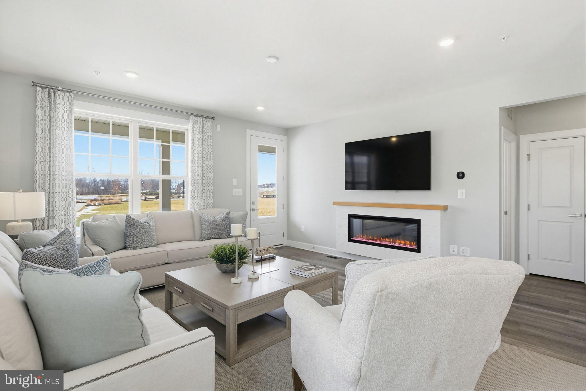 2598 Potting Shed Way Frederick, MD 21702 - Photo 5 of 32 a living room with furniture a fireplace and a flat screen tv