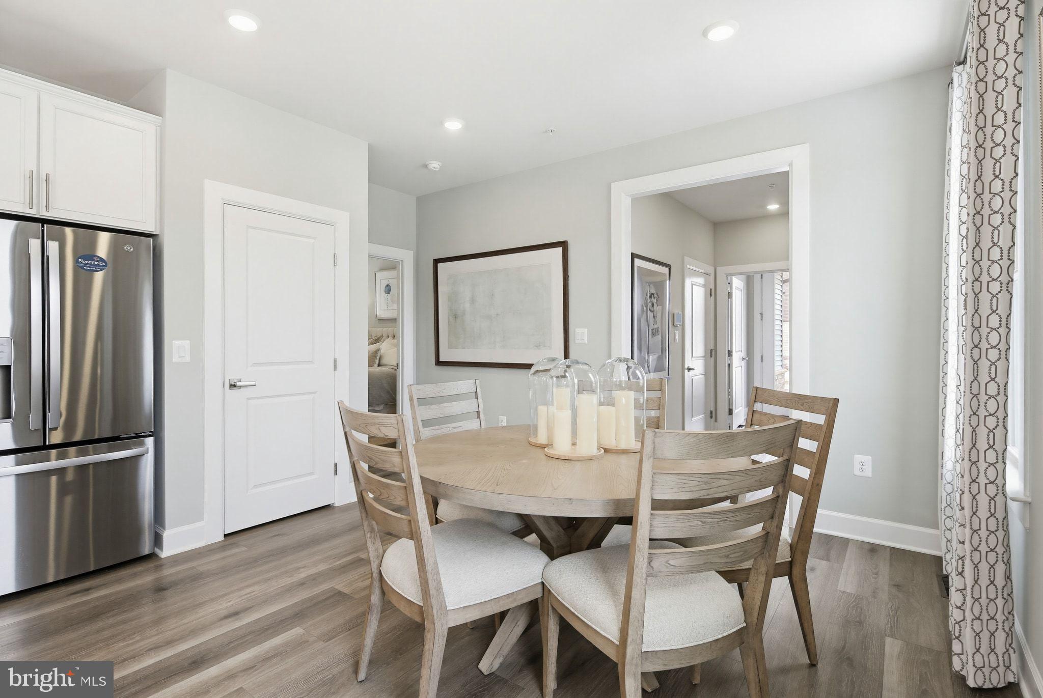 2598 Potting Shed Way Frederick, MD 21702 - Photo 9 of 32 a view of a dining room with furniture and wooden floor