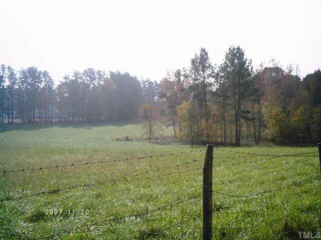 4118 Seven Paths Road Spring Hope, NC 27882 - Photo 2 of 6 a view of a field with an trees in the background