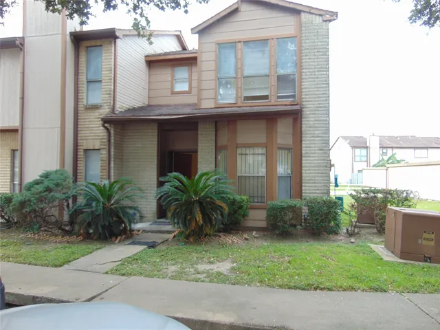 a house that has a palm tree in front of it