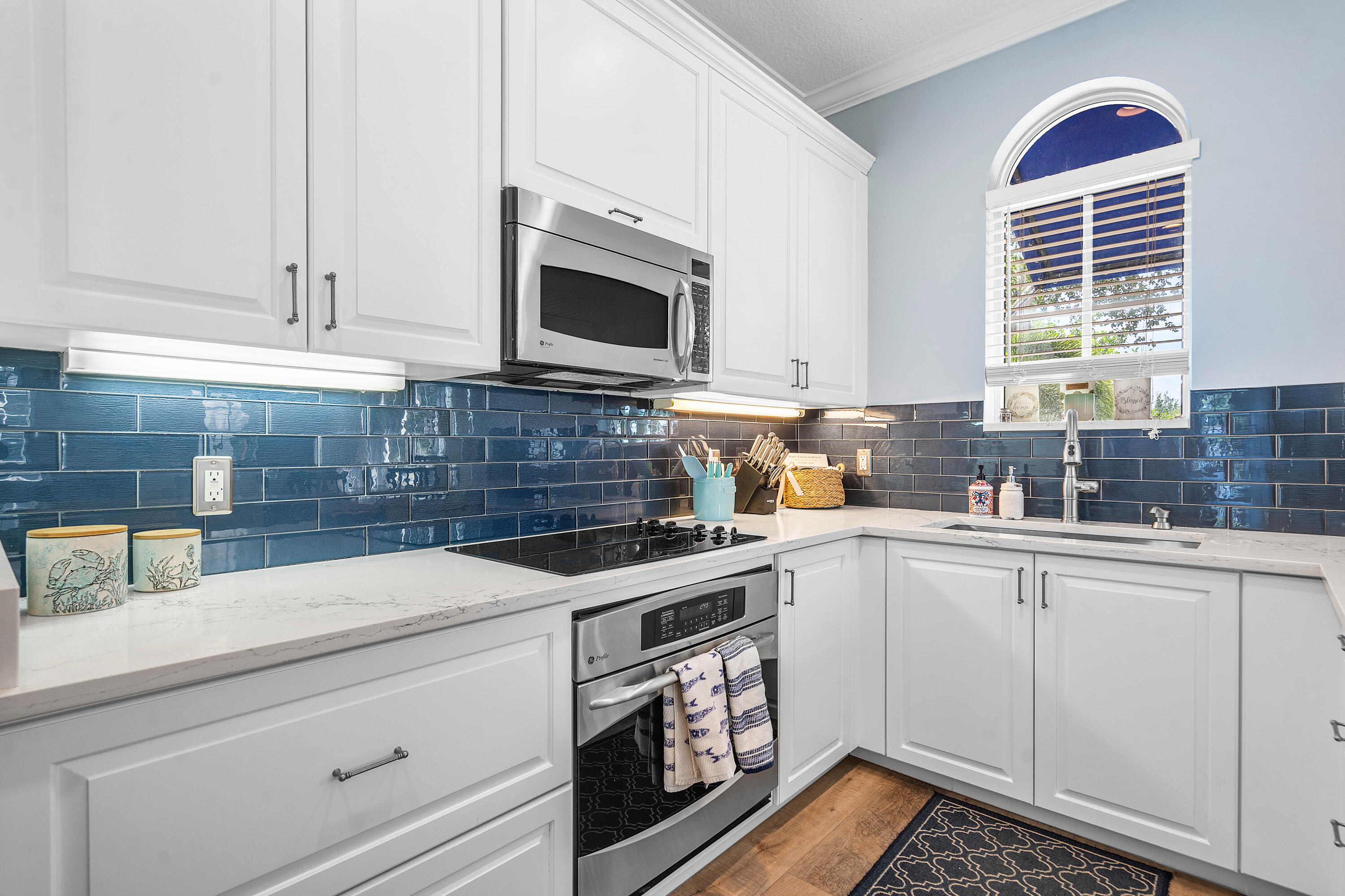 3261 Estancia Way Boynton Beach, FL 33435 - Photo 20 of 51 a kitchen with stainless steel appliances white cabinets and a stove top oven