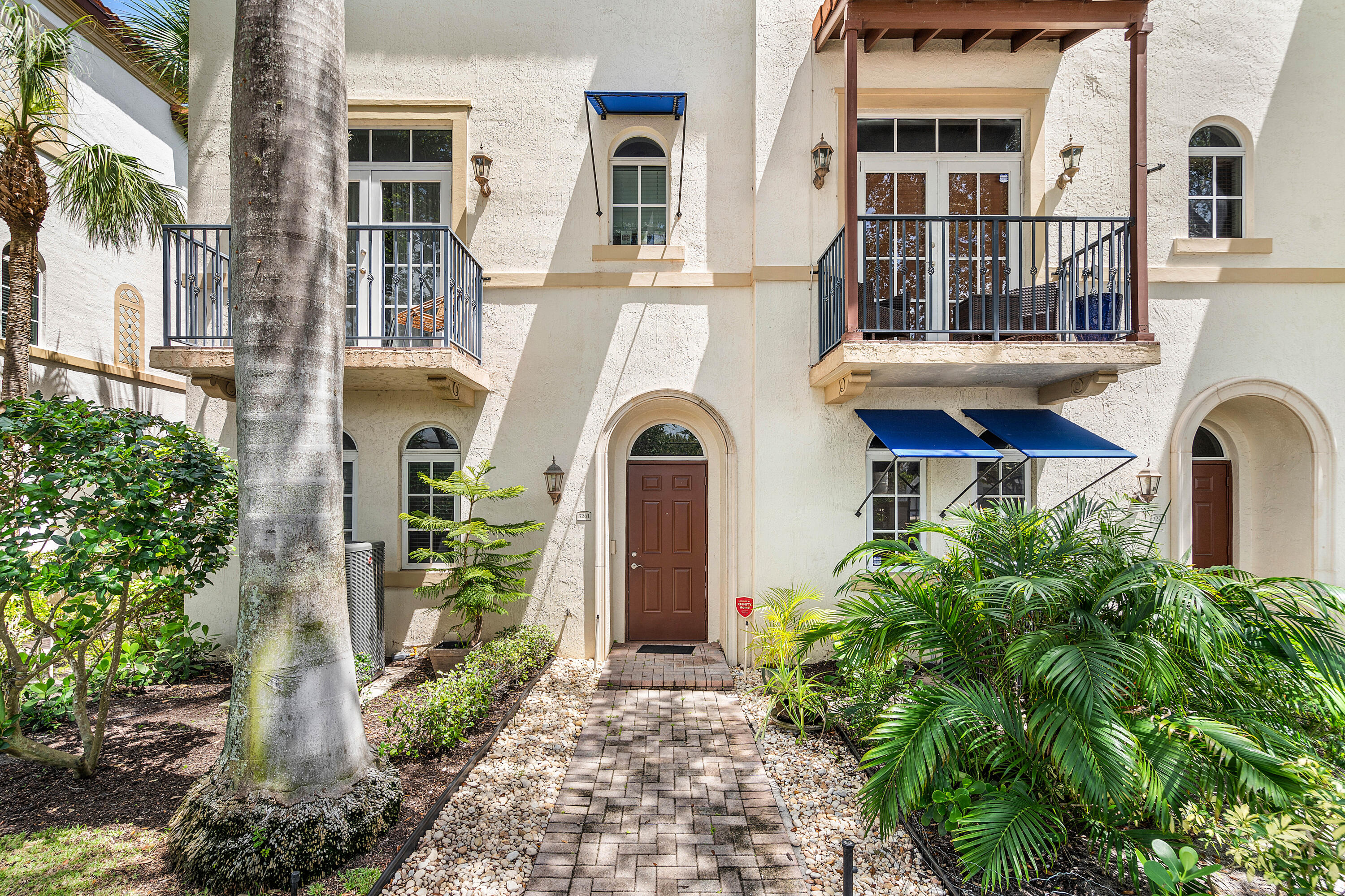 3261 Estancia Way Boynton Beach, FL 33435 - Photo 2 of 51 a front view of a house with a garden