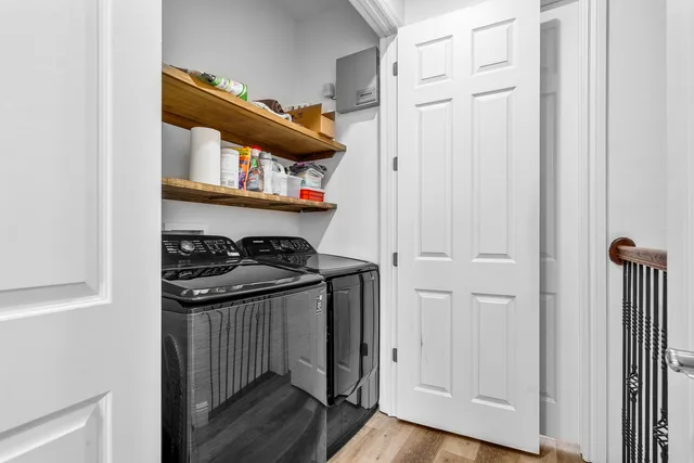 a view of a hallway with wooden floor and staircase