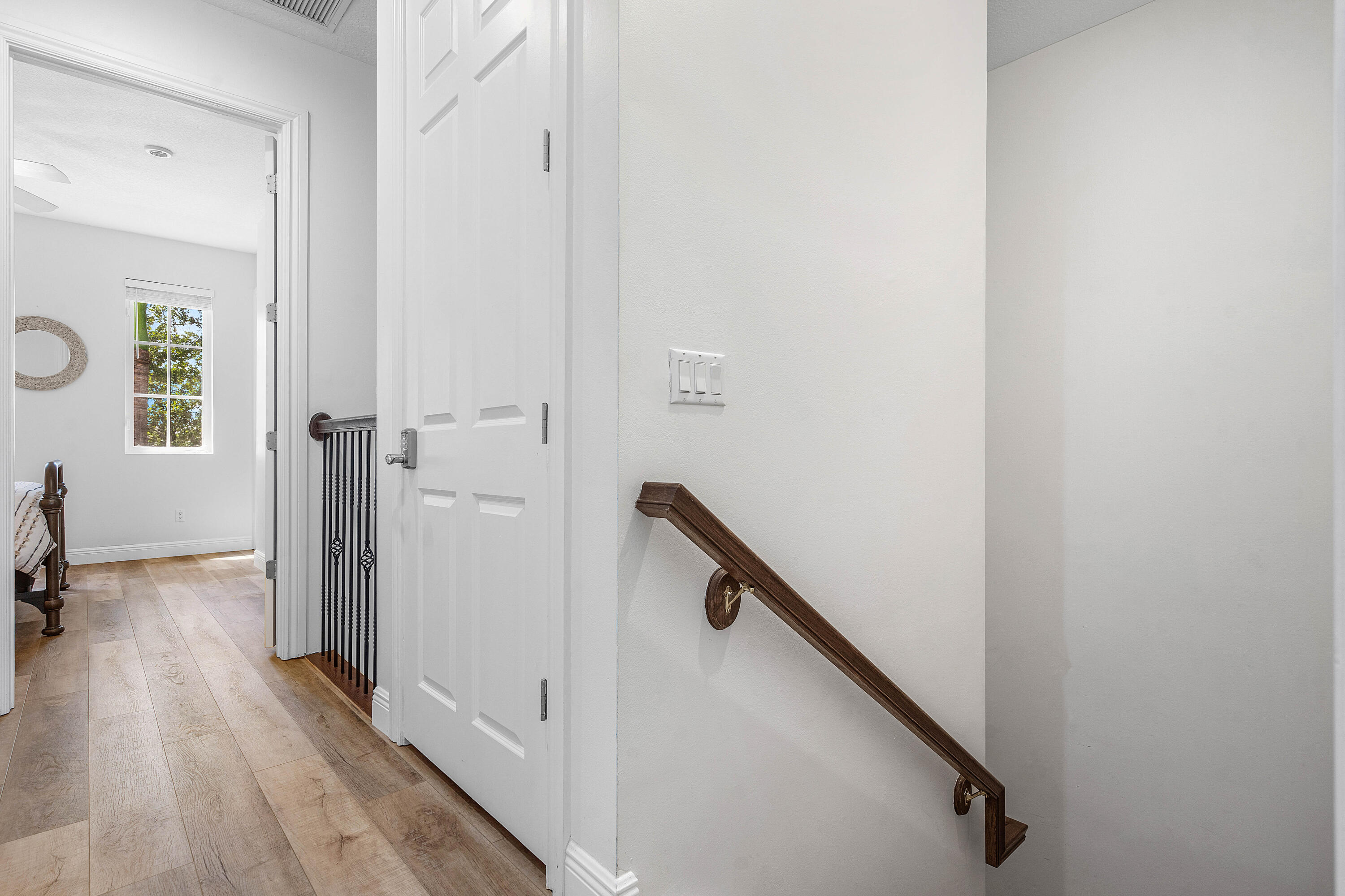 3261 Estancia Way Boynton Beach, FL 33435 - Photo 36 of 51 a view of a hallway with wooden floor and staircase