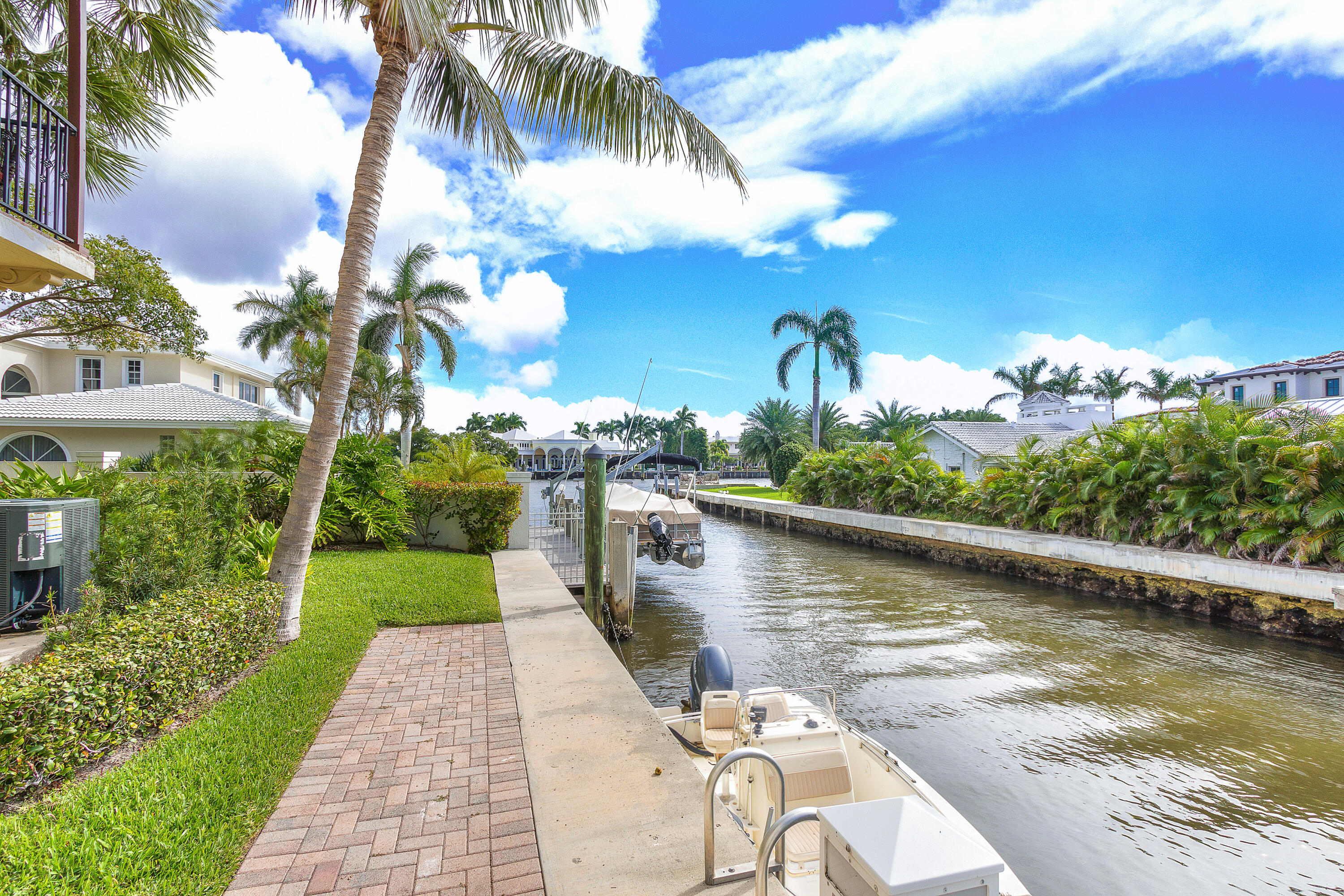 3261 Estancia Way Boynton Beach, FL 33435 - Photo 38 of 51 a view of a lake with a house in the background