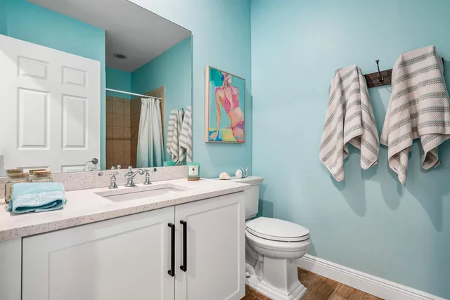 a bathroom with a toilet a sink and mirror