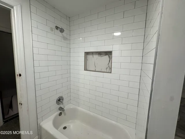 a bathroom with a bathtub and shower