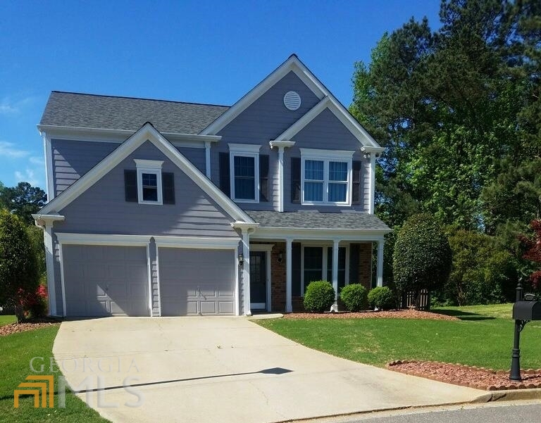 a front view of a house with a garden